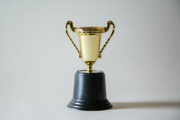 a golden award cup on a plain white background