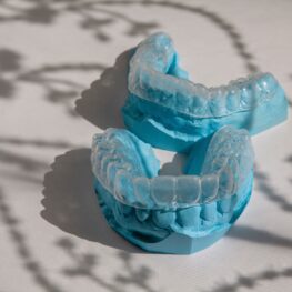 Invisalign retainers on top of the impressions from teeth